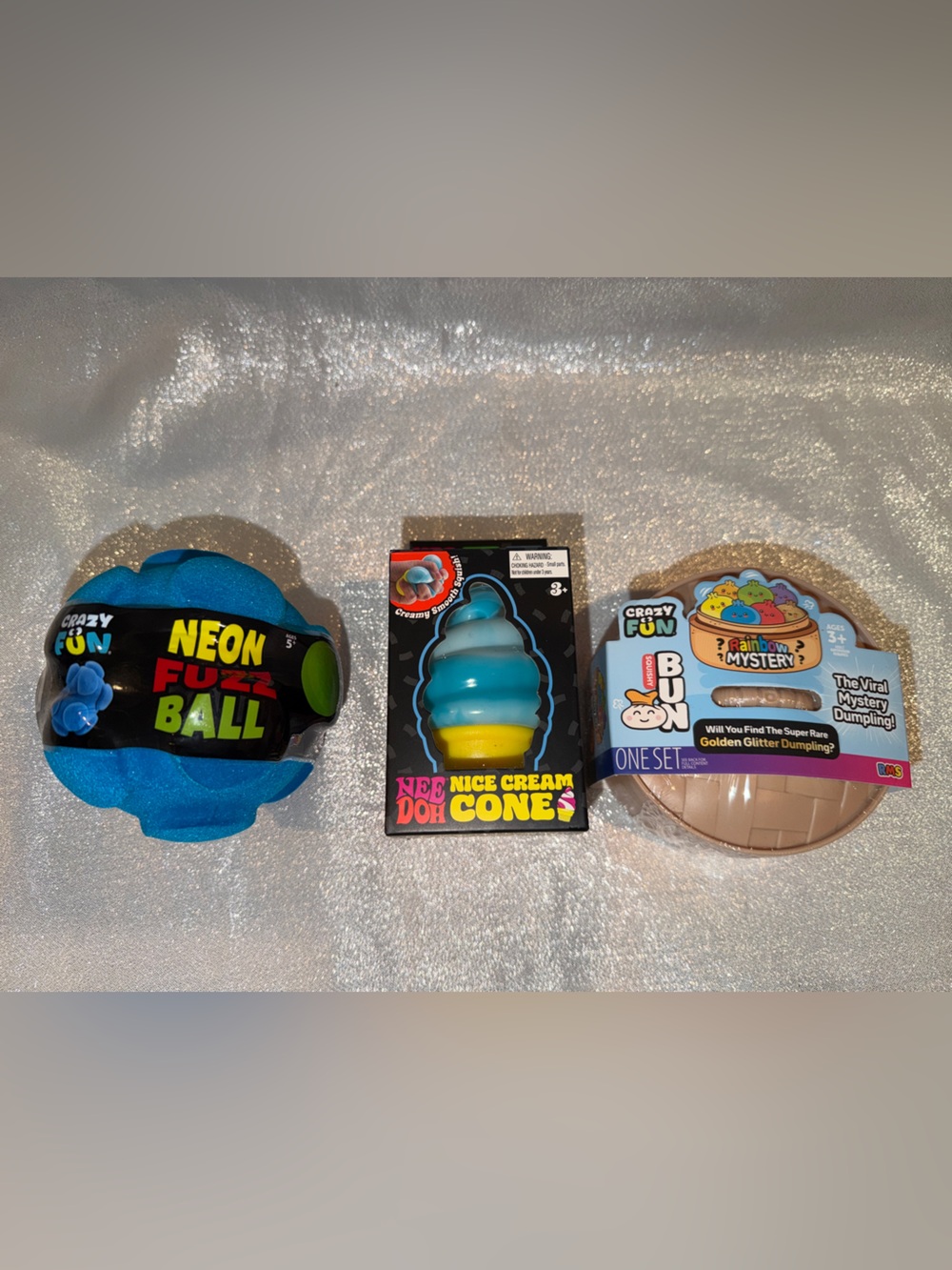 1 NeeDoh Ice Cream, 1 Glitter Mystery Dumpling, 1 Neon Fuzz Ball & 4 Gummy Drops